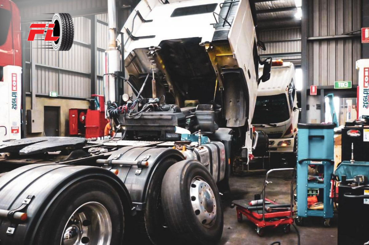 Truck undergoing maintenance in a professional workshop with opened cab and visible tyres, representing tyre care and safety procedures.