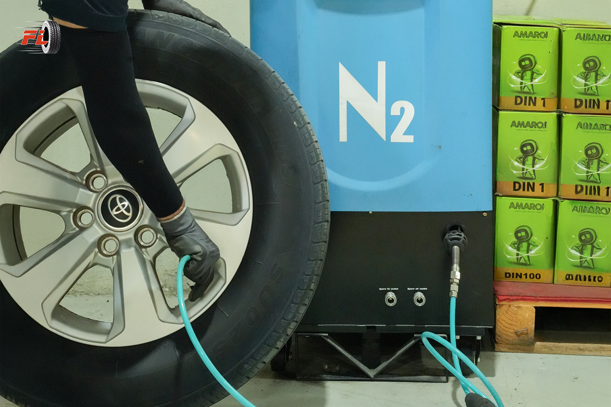 A technician at Fast Lane filling a car tyre with nitrogen gas using an N2 machine for better tyre performance and safety.