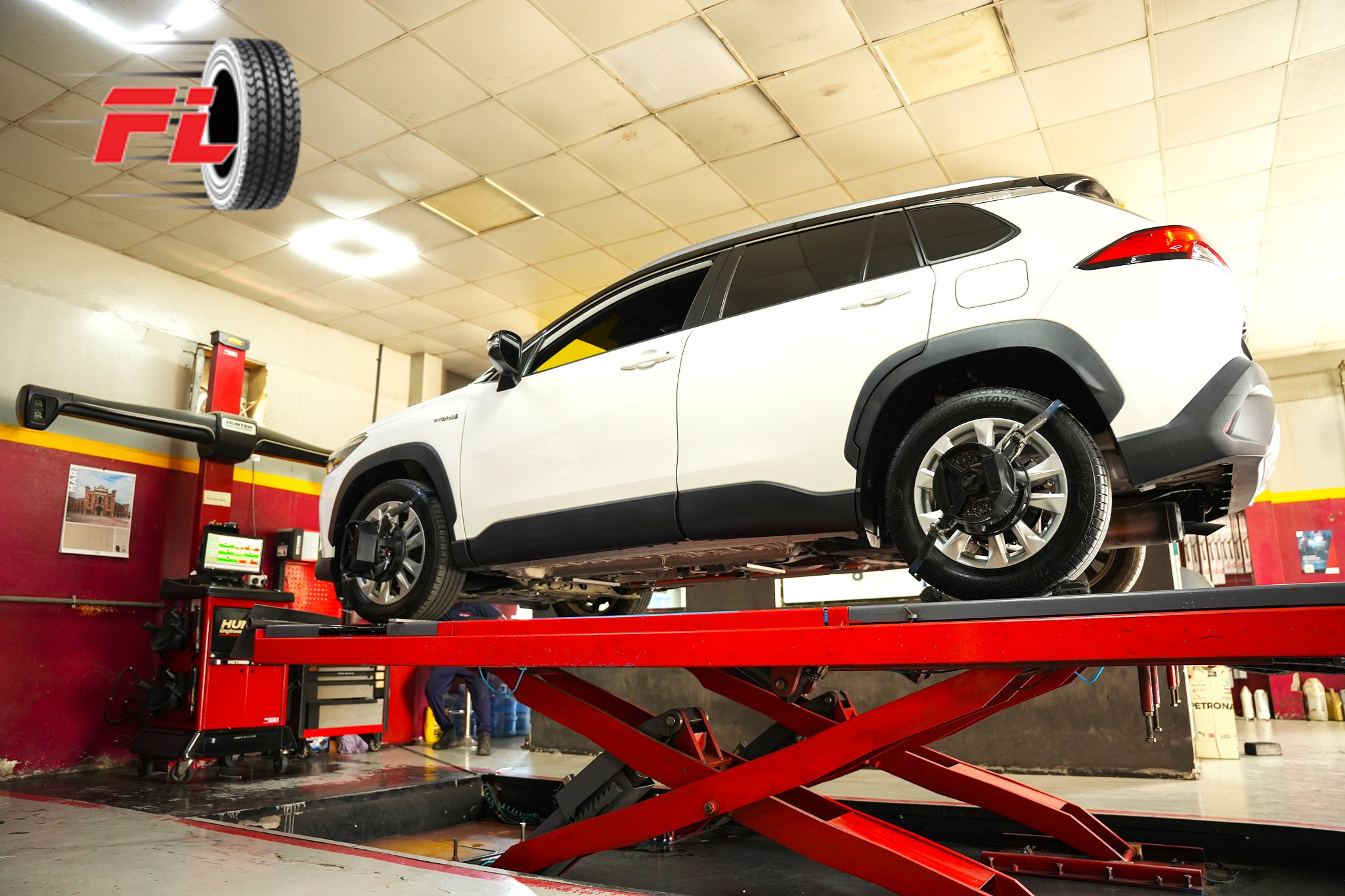 A technician performs precise wheel alignment on a hybrid SUV at Fast Lane Tyres — ensuring safe handling and longer tire life.